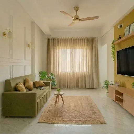 Restful bedroom at Atithi Aangan with a plush headboard and warm evening light